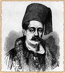 portrait noir et blanc d'un homme moustachu portant un fez