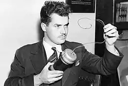 Jack Parsons tenant un objet dans ses mains.