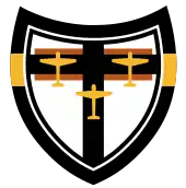 Emblème d'une unité de combat allemande avec la silhouette de trois avions jaunes sur une croix noire et un fond blanc.