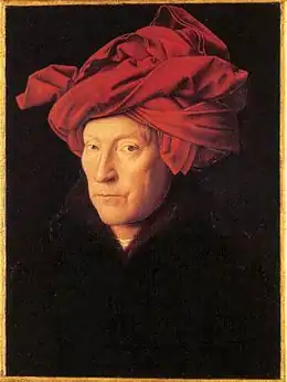 Portrait en buste sur fond noir d’un homme entre deux âges portant un turban rouge.