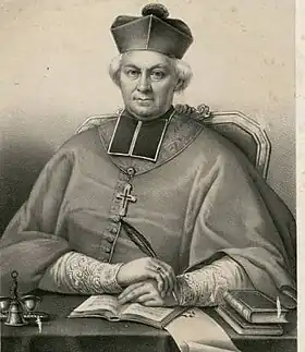 Photographie en noir et blanc d'un tableau représentant un évêque assis, derrière sa table de travail.