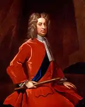 Portrait d'un homme assis vêtu d'un habit rouge, un bâton dans la main droite.