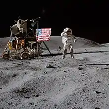 Le mythique drapeau américain encerclé de métal est placé devant le module lunaire pour une prise de photo des astronautes saluant le drapeau