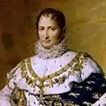 Gravure en couleur montrant Joseph Bonaparte assis sur un muret et tenant dans sa main gauche un livre ouvert.