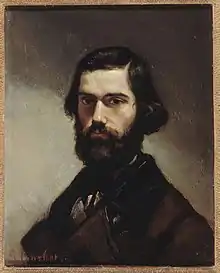 Peinture, Jules Vallès jeune est vêtu de noir, porte des cheveux mi-longs, une barbe épaisse et une moustache noirs également.