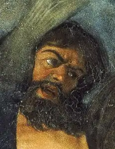 détail d'une peinture montrant le visage d'un homme brun et barbu.