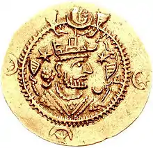 Côté face d'une pièce de monnaie représentant un homme à la tête couronnée