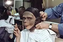 Une femme se fait maquiller en singe.