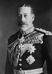 Homme barbu avec des yeux pales portant un uniforme avec de nombreuses médailles et décorations