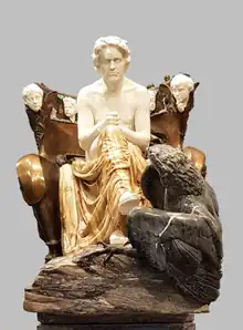Statue en marbre représentant Beethoven, assis sur un trône, avec un aigle à ses pieds.