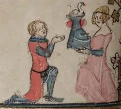 Un chevalier agenouillé (à gauche), portant par-dessus son armure un surcot rouge sans manches, reçoit un heaume cimé d'un cygne d'une dame debout, vêtue d'une robe rose. Détail d'une enluminure tirée d'un manuscrit du Roman d'Alexandre.