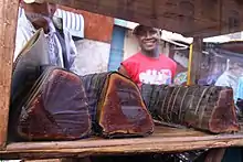 rouleaux épais marron foncé de pâte de cacahuète entouré de feuilles de banane