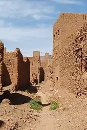 Un sentier parmi de hautes murailles de terre.