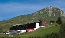 Bâtiment sur les flancs d'une montagne en été.