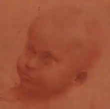 Dessin crayonné rouge sur rouge représentant la tête d'un bébé.