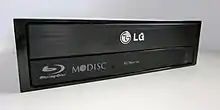 The M-DISC "swirl" logo on an LG Blu-ray optical drive.