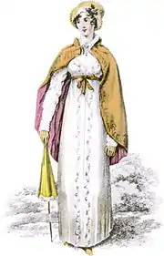 gravure ancienne montrant une jeune femme avec une robe à taille haute, un chapeau et une cape
