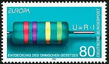 Timbre de couleur bleu turquoise représentant une résistance turquoise également avec des anneaux rouges, violet, jaune et vert clair. La loi U=R.I figure au-dessus du fil de la résistance. Mentions en majuscules blanches : Deutsche Bundespost le long du bord droit, en haut à gauche Europa, en bas à droite Entdeckung des ohmschen Gesetzes, valeur faciale de 80 pfennigs en bas à gauche.