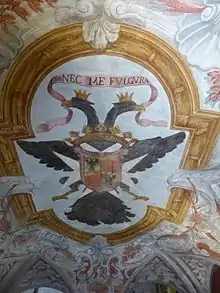 Photographie d'un plafond richement décoré, comprenant en son centre un aigle bicéphale.