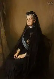 Tableau représentant une vieille femme assise en tenue de deuil.