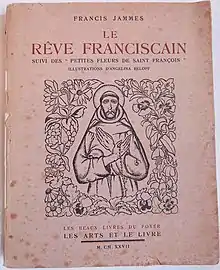 Couverture d'un livre ancien titré Le Rêve franciscain et portant une gravure de saint François, avec un chapelet à la main, entouré de fleurs.
