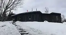 Photo d'un bâtiment long et bas dans un paysage couvert de neige