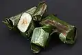 Lemper, glutinous rice filled with chicken wrapped in banana leaves.