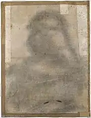 Feuille de papier portant le contour d'un dessin, visible par une ombre et un piquage.