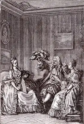 Gravure. Homme assis, tenant en l'air un chapeau, entouré de deux femmes assises qui l'écoutent.