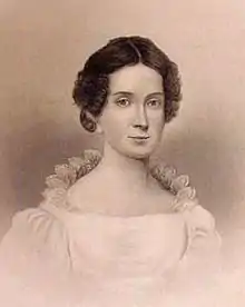 Portrait d'une femme aux cheveux ramenés en arrière et portant une robe blanche.