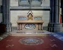 Photographie en couleurs du pavement et de l'autel de la chapelle vu de face.