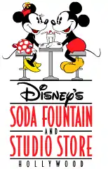 Logo noir et rouge de la boutique-restaurant avec au-dessus Minnie et Mickey attablés face à face devant un milkshake avec deux pailles.