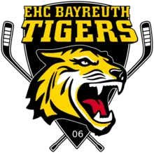 Logo représentant une tête de tigre devant deux crosses croisées et surmontée du texte "EHC BAYREUTH TIGERS"