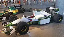 Photo de profil gauche de la Lotus 102, à la livrée blanche et verte