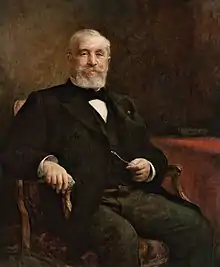 Peinture d'un homme barbu et moustachu, assis sur un fauteuil à accoudoirs.