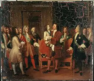 Tableau montrant le tsar en habit rouge portant dans ses bras le petit roi Louis XV en présence de dignitaires revêtus de costumes luxueux et coiffés de perruques.