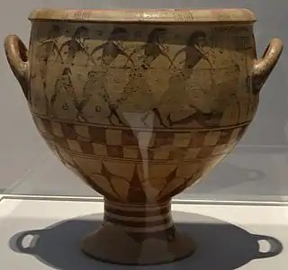 Vase appelé Aristonotos (Cerveteri), où cinq guerriers (de gauche à droite) attaquent un sixième au sol (à droite).