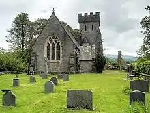 Exterior of 19th century neo-gothic church surrounded by a country churchyard