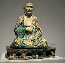 Photographie d'une sculpture en céramique représentant un luohan bouddhiste