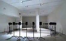 Rows of speakers displayed in a gallery.