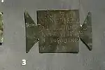Ex-voto inscrit en bronze en forme de tabula ansata, découvert dans le camp romain de Carnuntum. AE 2005, 1233 : Sextus Titi/us Moderatus / c(enturio) leg(ionis) XIIII G(eminae) / M(artiae) V(ictricis) Iovi Optimo / Helipolitano / v(otum) s(olvit) l(ibens) m(erito).