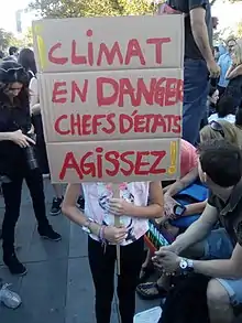 Pancarte en carton sur laquelle est écrite « Climat en danger, chefs d'état agissez ».
