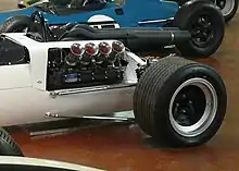 Photo de la partie arrière gauche de la McLaren M2B, où est apparent le moteur V8 Ford