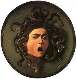 Peinture d'une tête coupée, grimaçante, la chevelure faite de serpents.