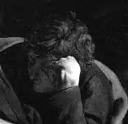 Détail d'une peinture photographiée en noir et blanc où un homme a la tête posée sur son poing fermé.