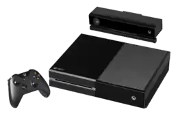Console de jeu : boitier rectangulaire de couleur noire posé à plat, avec une manette et un périphérique (boitier rectangulaire noir), sans fil.