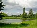 Le parc du château, vaste jardin anglais parsemé de pâturages, avec l'un des étangs.
