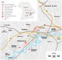 Carte géographique sur fond gris indiquant les différents secteurs du camp et leur nom accompagnés de sigles tracés en rouge.