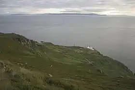 Le Mull of Kintyre et son phare (premier plan) et l'Irlande (arrière-plan) séparés par le canal du Nord