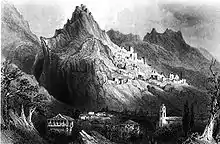 gravure noir et blanc : un village au pied d'une montagne avec des ruines